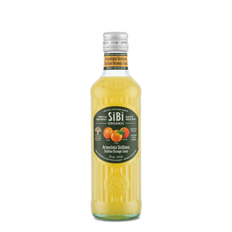 A 355ml glass bottle of Sibilla Organic Sicilian Orange Soda, featuring a green label with oranges and text, filled with yellow-orange soda from select cultivars and topped with a silver cap—ideal for Italian cafés.