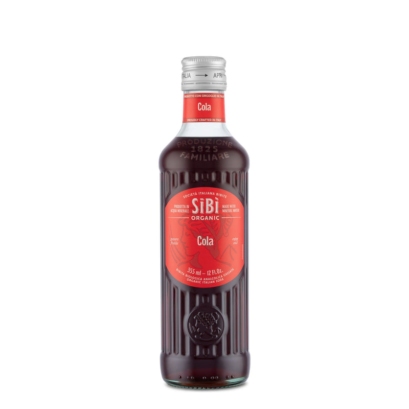 A 355ml Sibilla Organic Italian Cola in a glass bottle with red label and silver cap stands upright on a white background, showcasing its dark brown soda made with organic botanicals and mineral water.