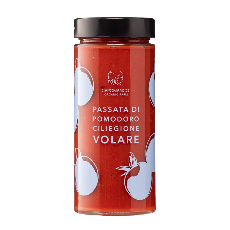 A glass jar of Capobianco Vulcano Gift Box Trio, featuring organic tomato purees made from Italian tomatoes, with a label decorated with white tomato illustrations.