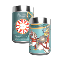 Two cylindrical tins with silver lids: one shows a medieval knight on a white horse, the other features a colorful design with “Sicily” and “Morettino”—Limited Edition Morettino I Pupi Siciliani Carlo Magno Ground Coffee (250g).