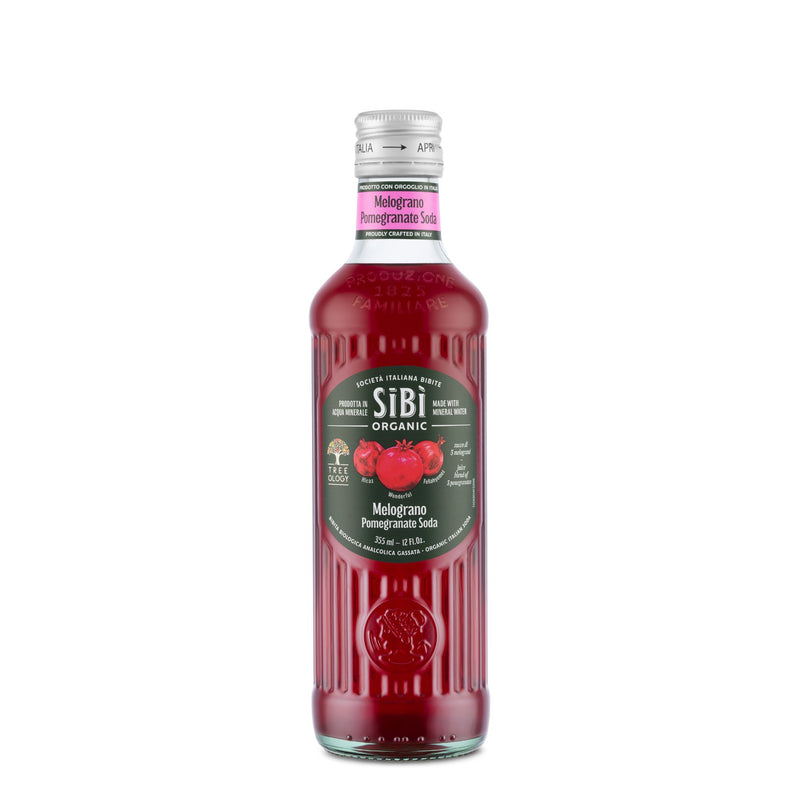 A glass bottle of Sibilla Organic Pomegranate Soda (355ml) with dark red liquid, black label featuring red pomegranates and text, a pink neck label, silver cap, and naturally tart flavor.