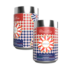 Two vibrant Morettino Boutique Sicilian Carretto coffee tins (250g) feature geometric red, blue, and white designs with shiny silver lids. Each upright tin showcases Sicilian style and contains premium ground coffee.