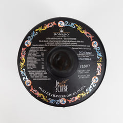 Top-down view of a round bottle cap with colorful patterns and Italian text, marking it as Romano Frantoio’s Testa di Moro, Le Sciare, Extra Virgin Olive Oil (0.5L/16.9oz). Expiry date and product info are also visible.